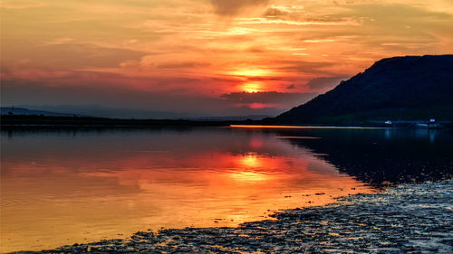 Scenic view of sea against orange sky