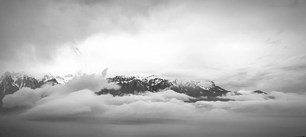 Scenic view of snow covered mountains against sky