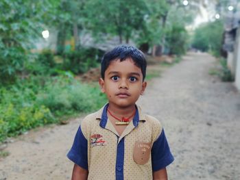 Portrait of boy standing on land