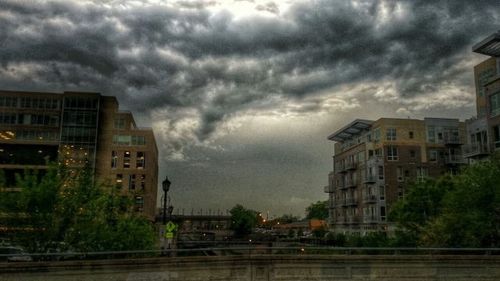 Buildings against cloudy sky