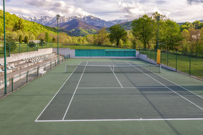 Tennis court. trees and mountains around the tennis court in nature.