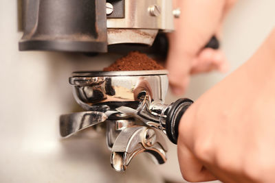 Close-up of hand making coffee