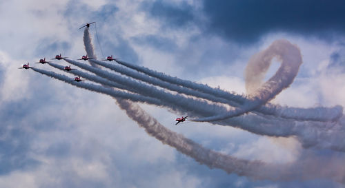 Low angle view of airshow against sky