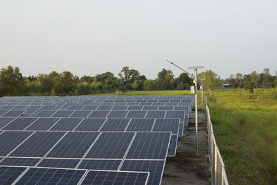 Solar panels on field against clear sky