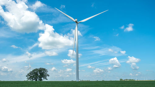 Windmill on field against sky