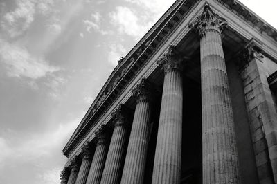 Low angle view of column against cloudy sky