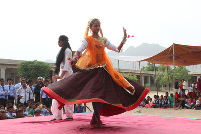 Group of people dancing at music concert