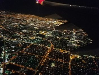 Aerial view of illuminated city buildings at night