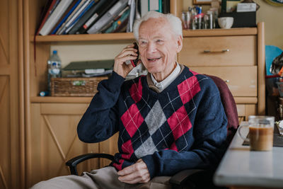 Young man smiling while sitting at home