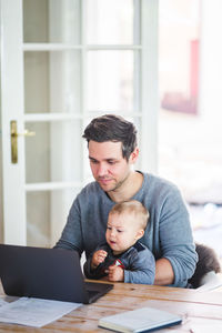 Father with baby on table