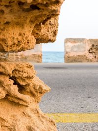 Rock formation on beach against sky