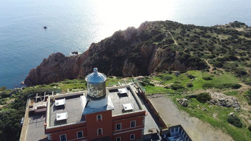 High angle view of buildings by sea against sky