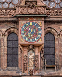 Clock on the facade of cathedral of strasbourg