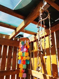 Low angle view of decorations hanging on wood