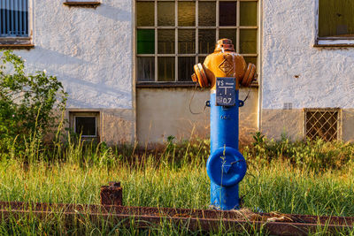 Woman standing in front of house