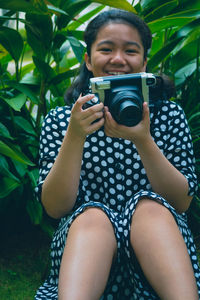 Portrait of beautiful young woman using mobile phone