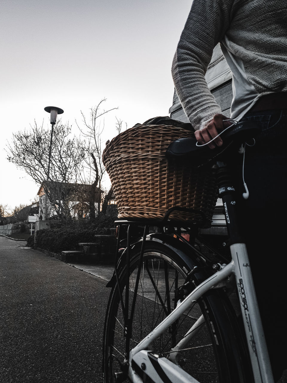 MIDSECTION OF MAN WITH BICYCLE ON STREET