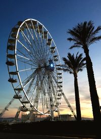 Low angle view of ferris wheel against sky