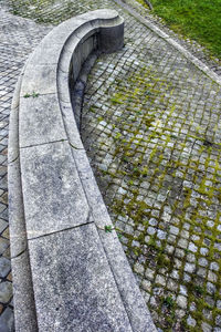 High angle view of stone wall by footpath