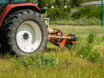 Close-up of abandoned tractor on field