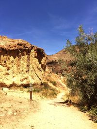 Scenic view of rocky mountains against blue sky
