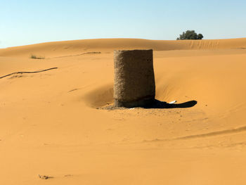 Sand dune in desert against clear sky