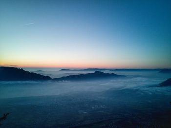 Scenic view of landscape against clear sky during sunset