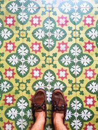 Low section of people standing on tiled floor