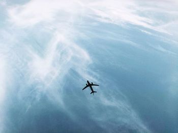 Low angle view of airplane flying in sky