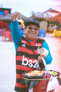 Portrait of smiling man holding drink