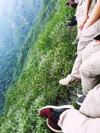 Low section of woman sitting on mountain