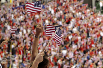 Spectators holding flags in stadium