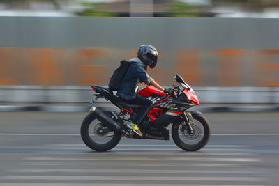 Man riding motorcycle on road