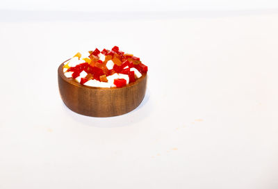 Close-up of cake on table against white background