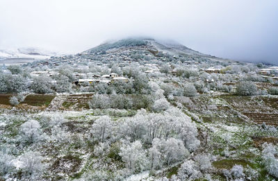 Aerial view of buildings against sky during winter