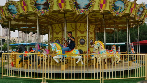 People sitting in amusement park ride