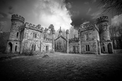 Historic building on field against sky