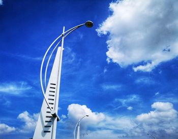 Low angle view of street light against blue sky