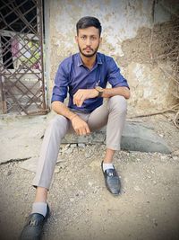 Portrait of young man sitting outdoors