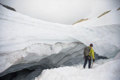 Mountaineer and explorer, paul mcsorley, enters a glacial cave.