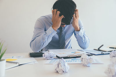 Rear view of man working on table