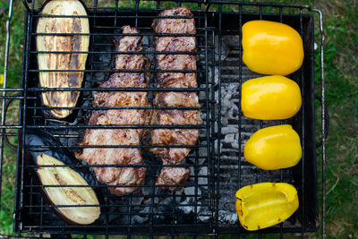High angle view of yellow sweet pepper on barbecue