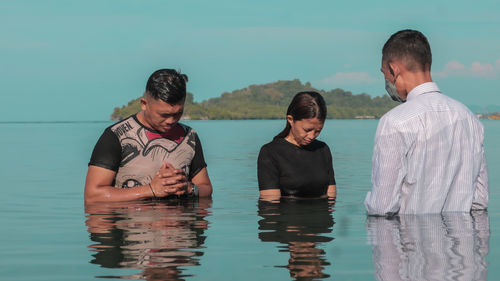 View of an adventist church minister performing a baptism