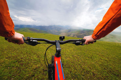 Pov of a mountain biker riding in difficult terrain. hands and cyclist in nature overlooking the