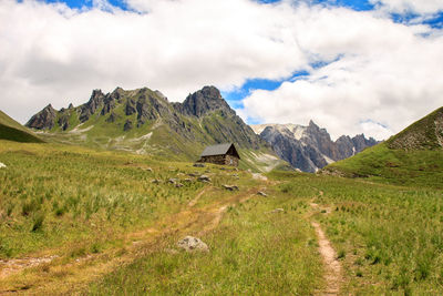 Scenic view of field and mountains against sky