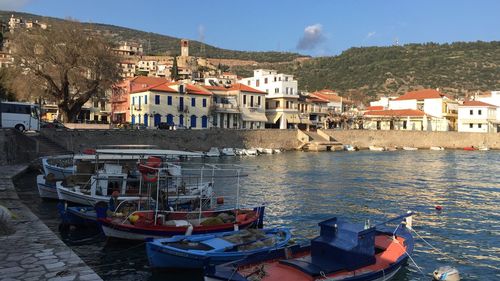 Boats in water with city in background