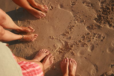 Low section of person on sand at beach