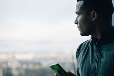 Portrait of young man using mobile phone