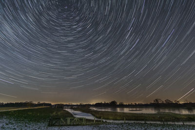 Scenic view of lake against sky at night