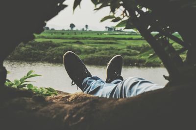 Low section of man relaxing on grass